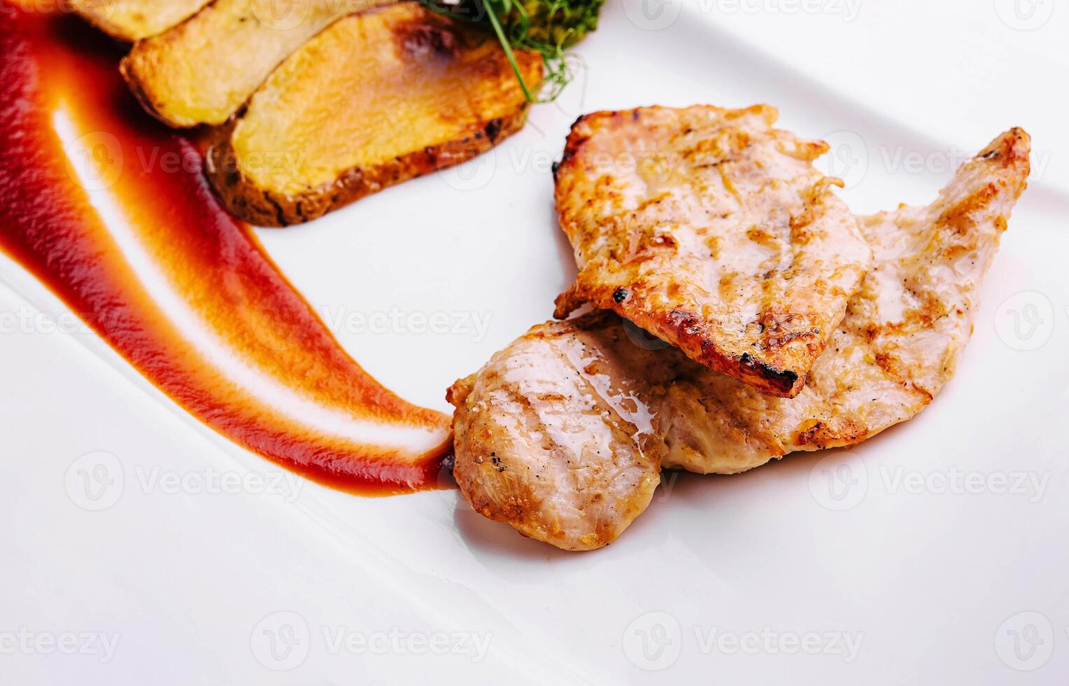Plate with two chicken fillet steaks, with fried potatoes photo
