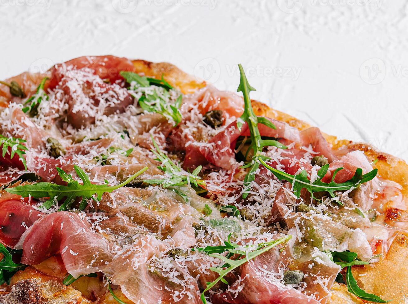 square pizza with prosciutto and arugula photo
