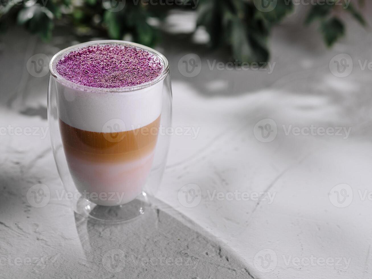 Colorful layered latte in a glass mug photo