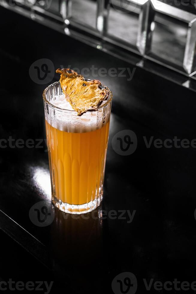 Dynamic splash in glass of orange juice photo