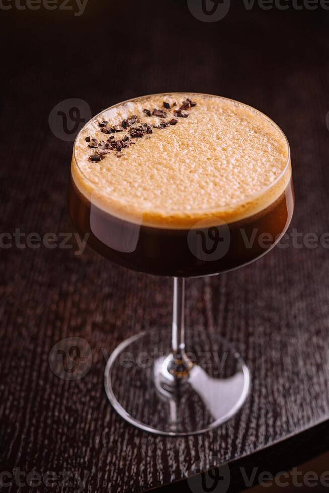 Elegant espresso martini cocktail on dark background photo
