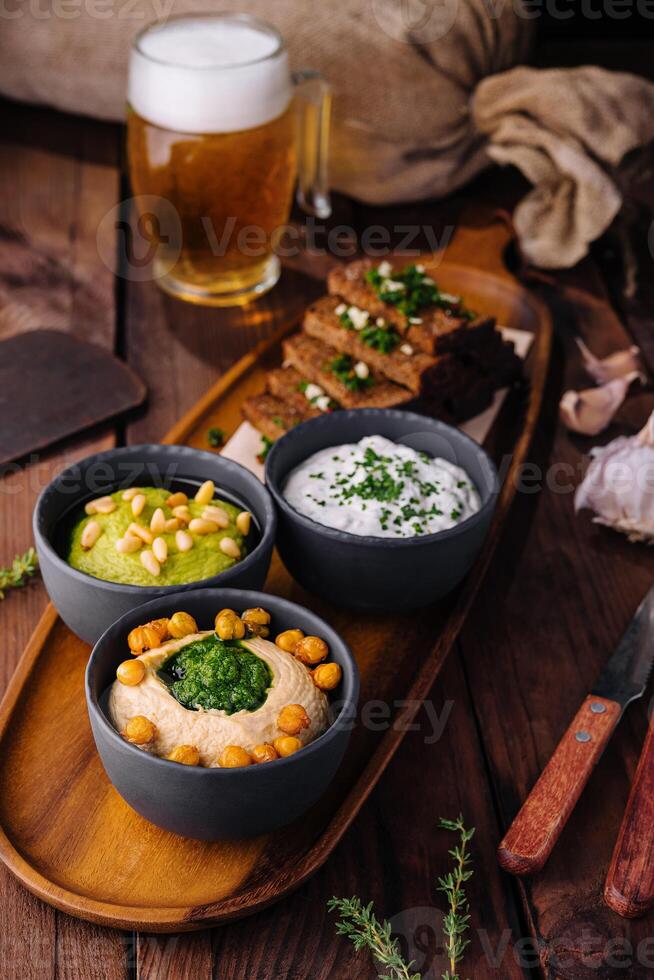 Gourmet beer snack platter with dips and toast photo