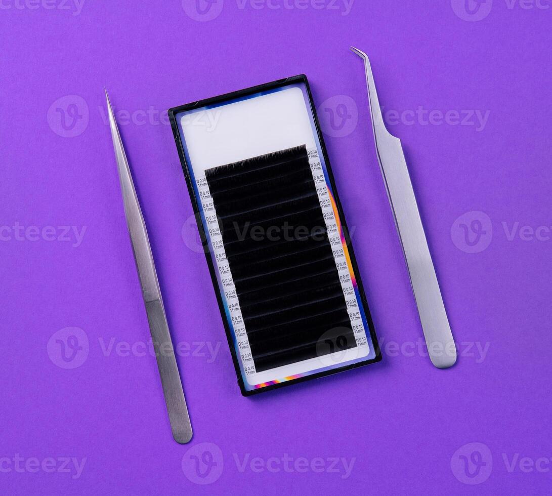 Eyelash extension supplies on purple background photo