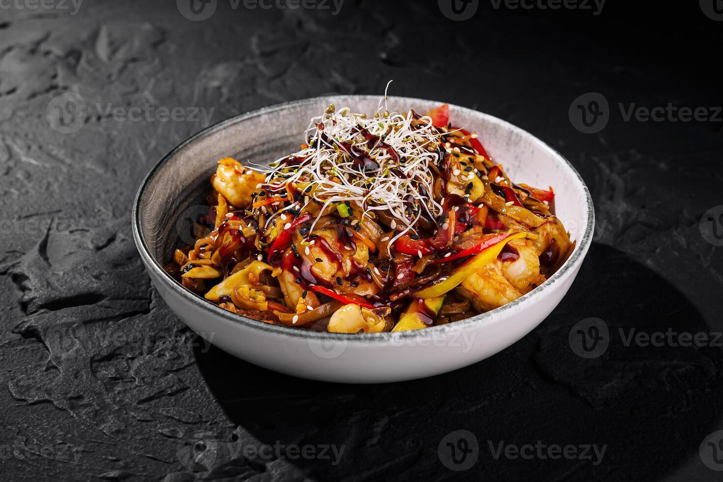 Spicy asian noodle dish on dark background photo