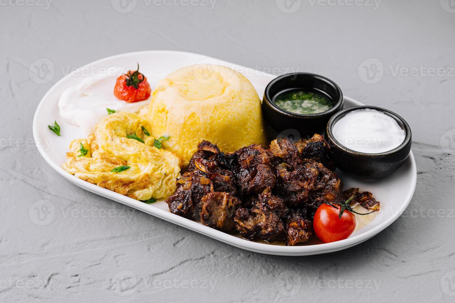 Traditional couscous dish with meat and sauces photo