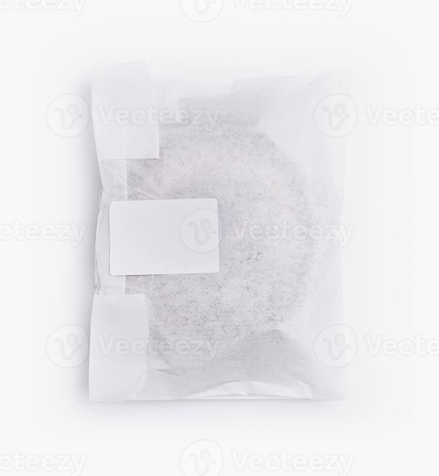 Sealed paper bag with blank label on white background photo