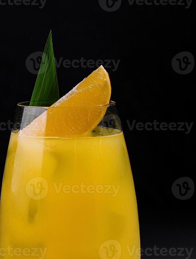 Fresh orange cocktail on dark background photo