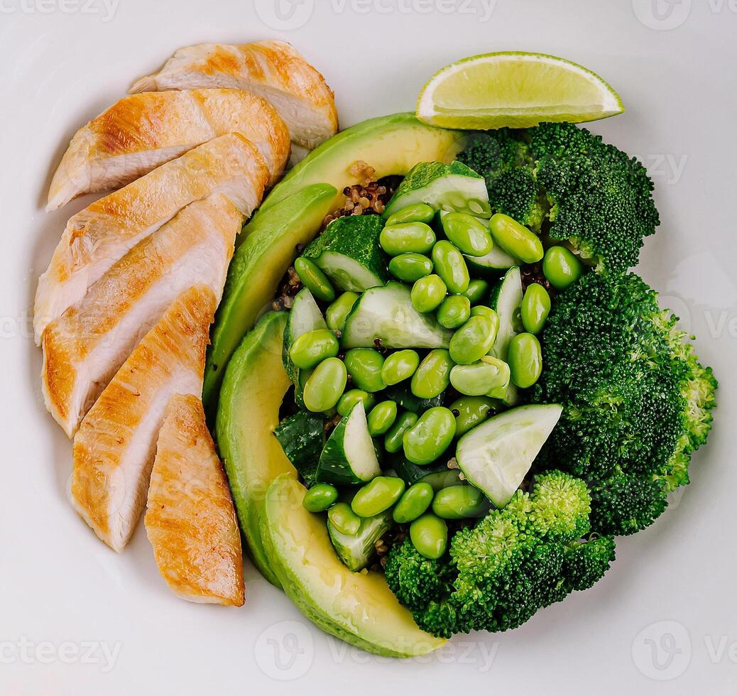 Healthy grilled chicken plate with vegetables and lime photo