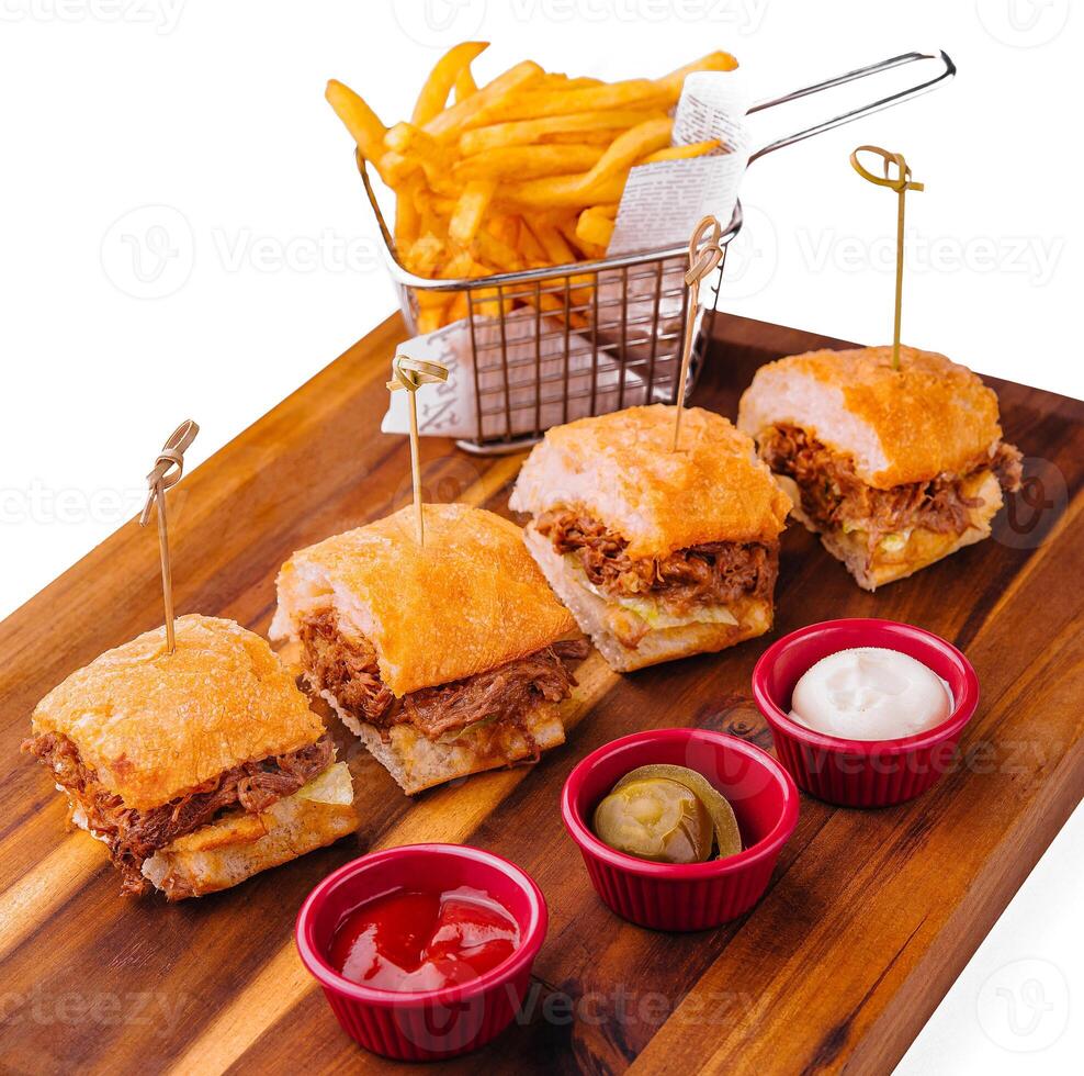Tasty slider burgers with fries and dipping sauces photo
