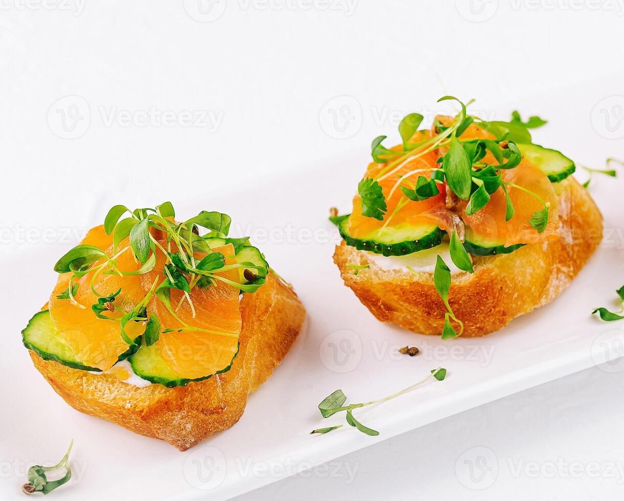 Fresh salmon canapes with microgreens photo