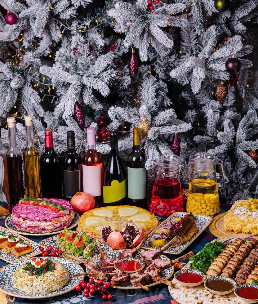 Festive holiday feast with decorated christmas tree photo