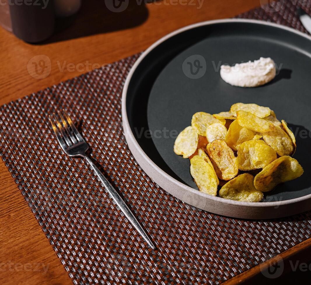 Elegant table setting with gourmet chips and dip photo