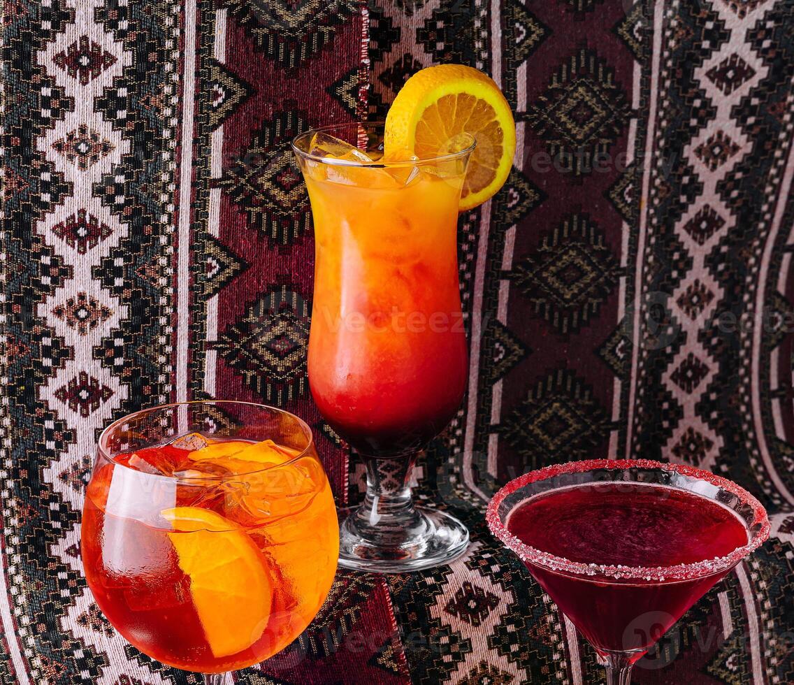 Assorted cocktails on a patterned backdrop photo