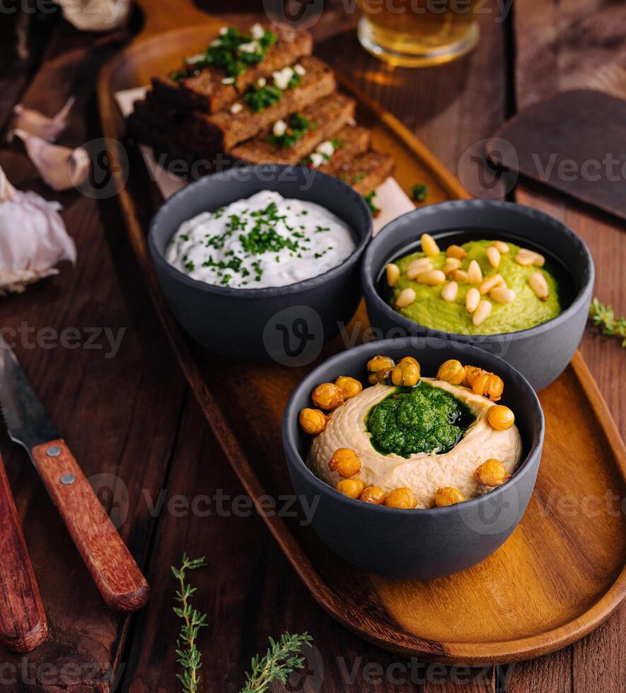 Gourmet beer snack platter with dips and toast photo