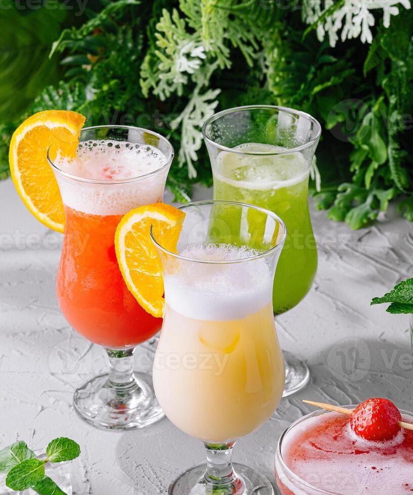 Variety of refreshing cocktails on rustic table photo