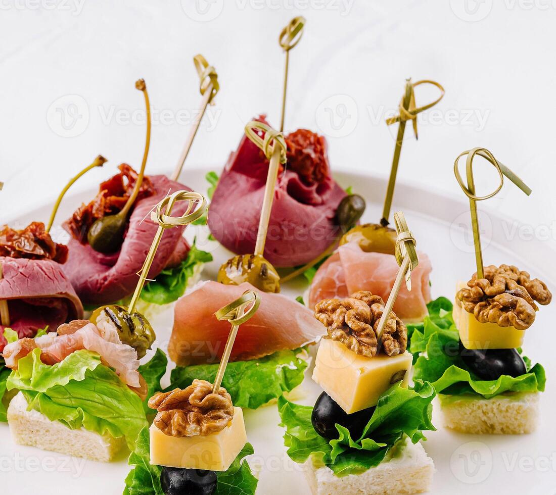 Gourmet canapes platter on white background photo