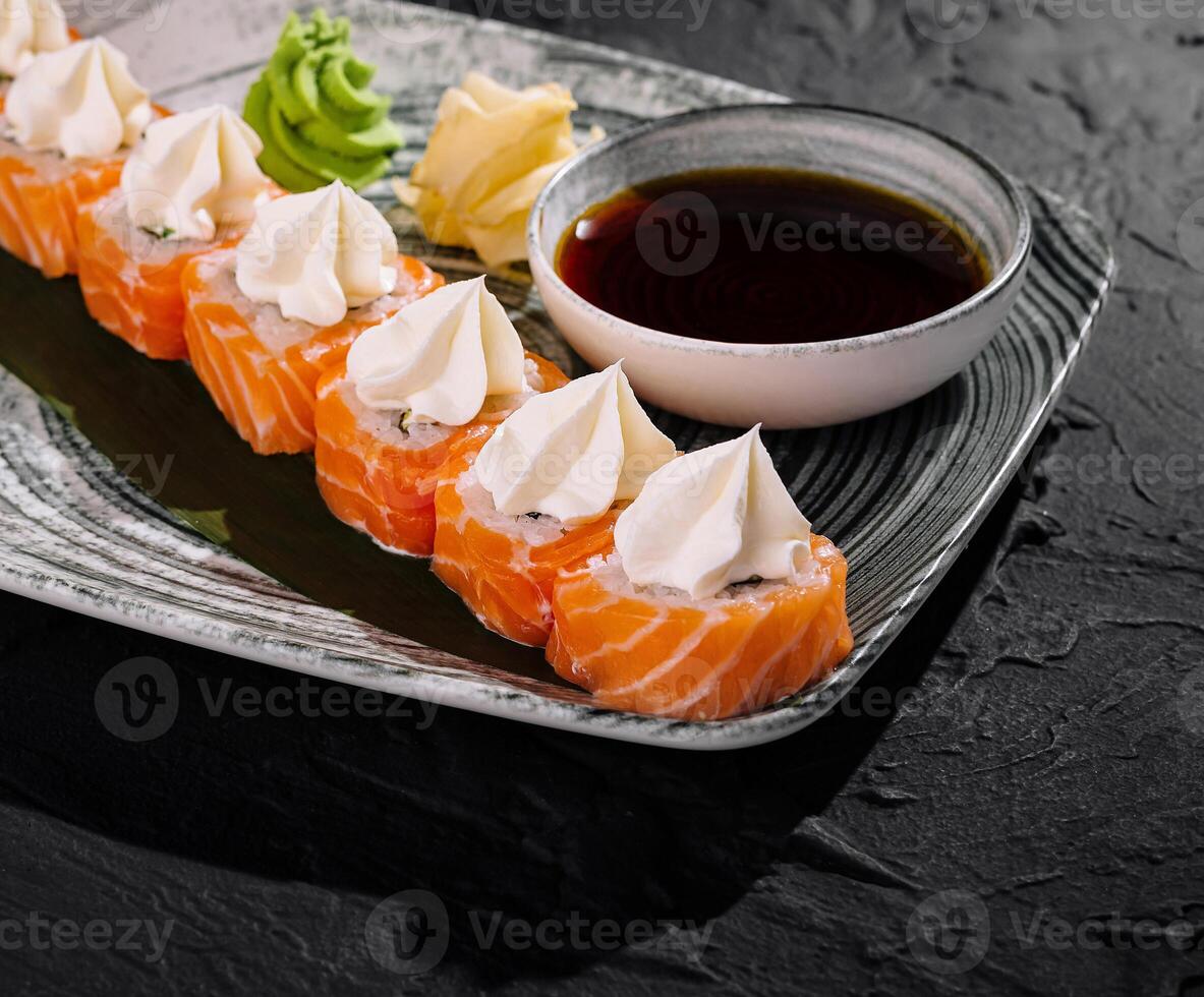 Gourmet sushi platter with cream cheese and soy sauce photo