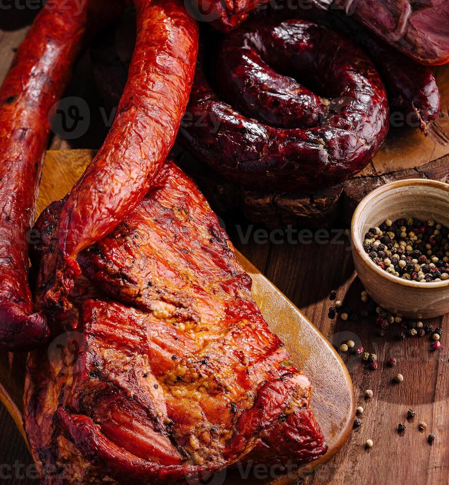 Assortment of smoked meats on wooden board photo
