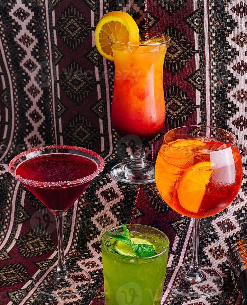 Assorted cocktails on a patterned backdrop photo