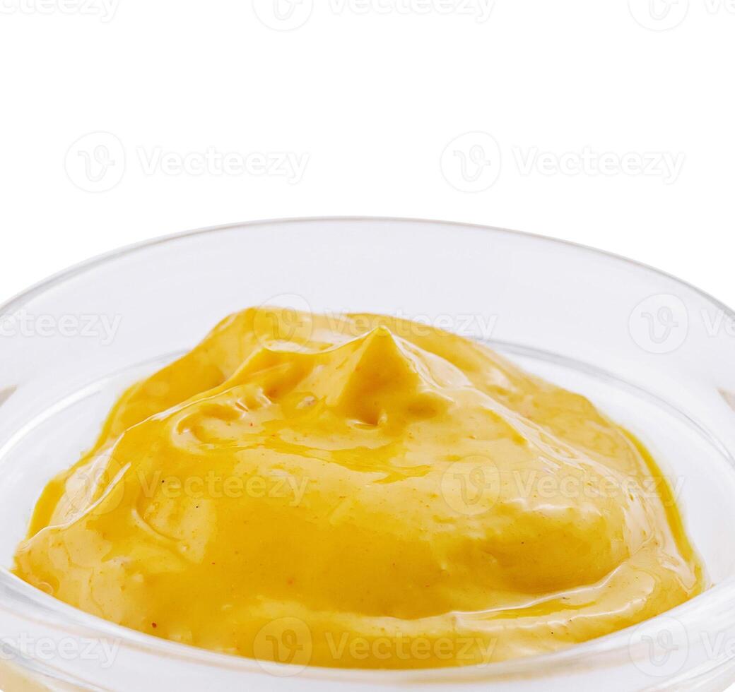 Bowl of creamy mustard sauce isolated on white photo