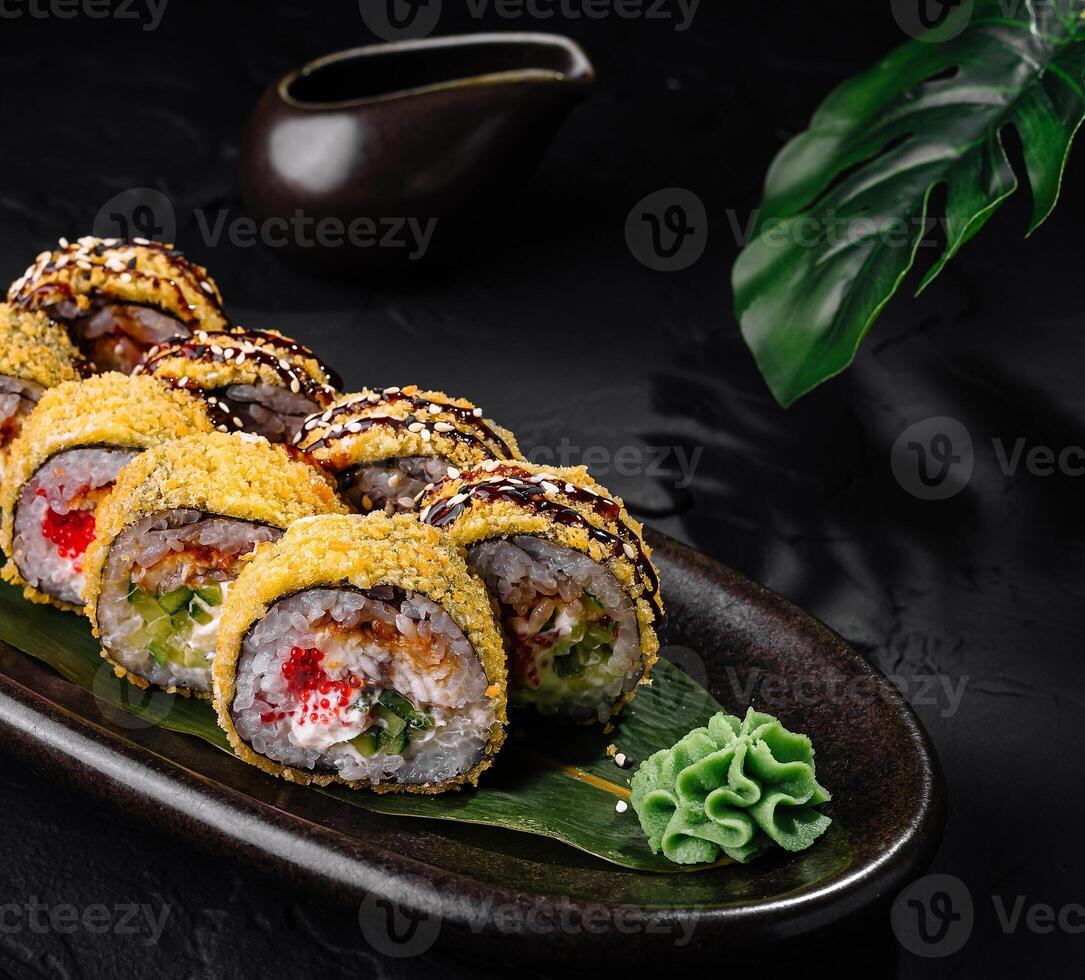 Delectable sushi rolls plated on dark slate background photo