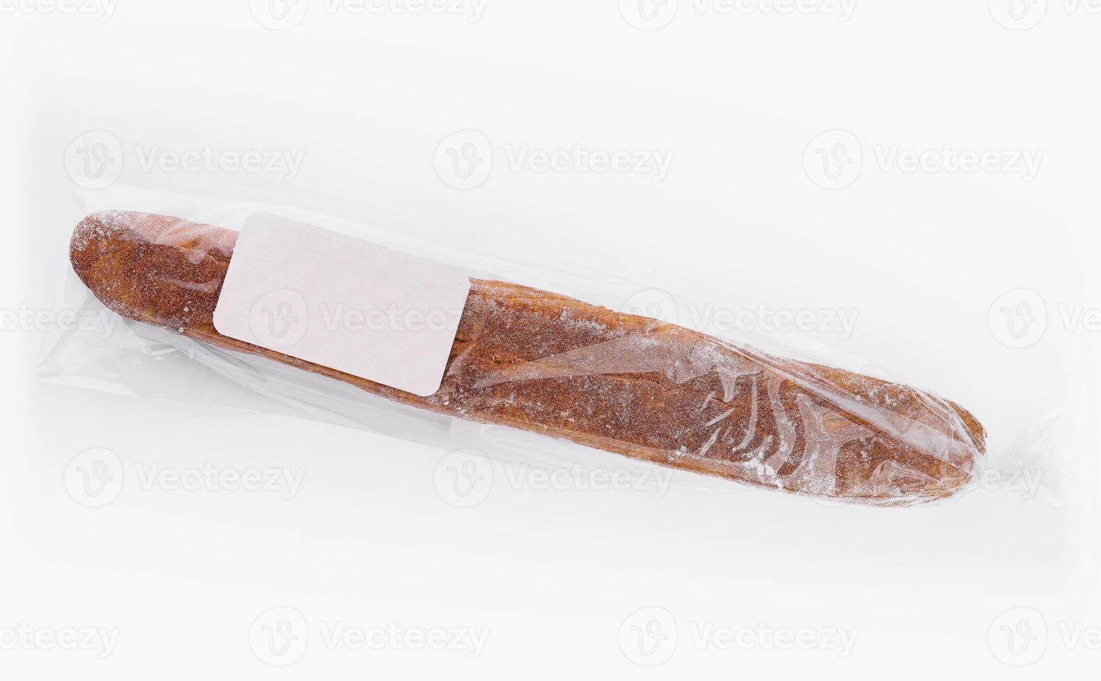 Fresh baguette in plastic packaging photo