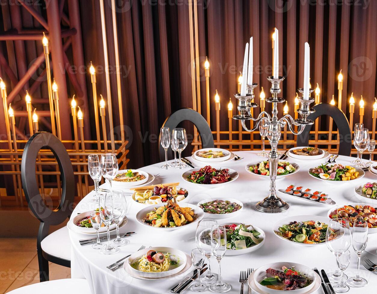 Elegant dinner table setup with candlelight photo