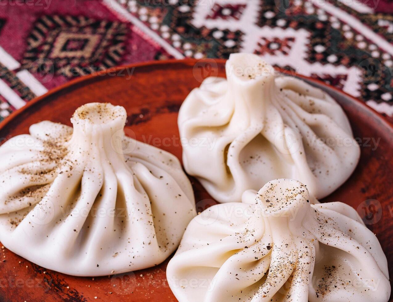 Traditional georgian khinkali on rustic plate photo