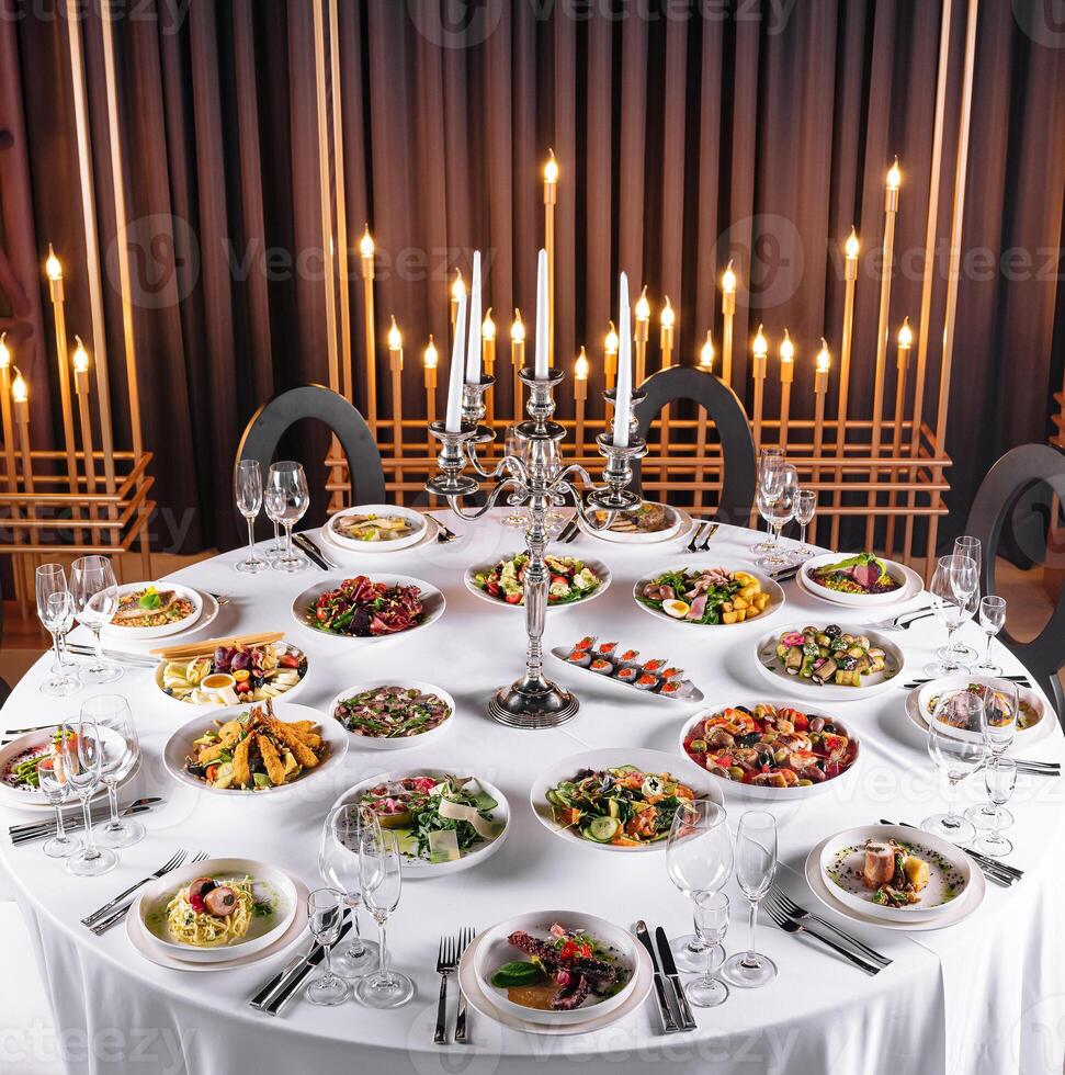 Elegant dinner table with gourmet dishes and candlelight photo