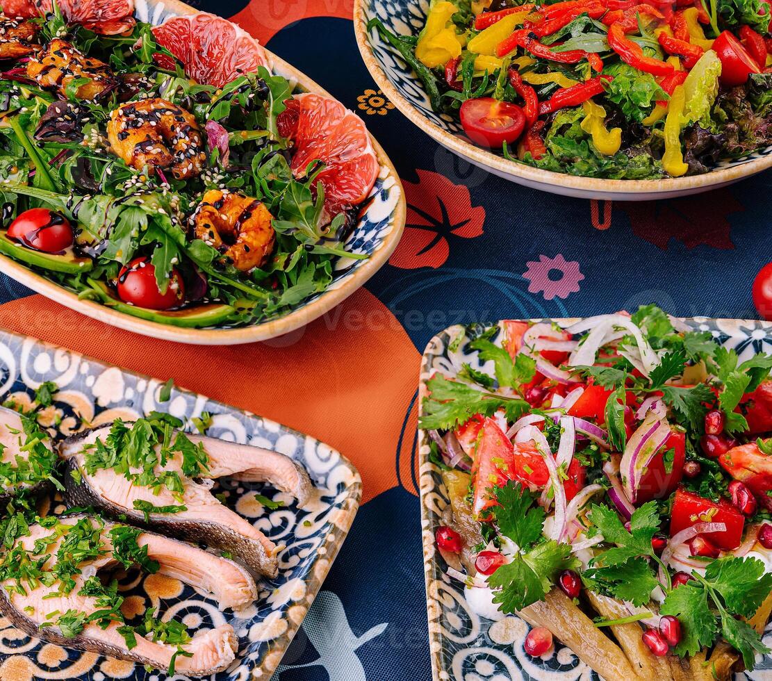 Colorful assortment of mediterranean dishes on patterned tablecloth photo
