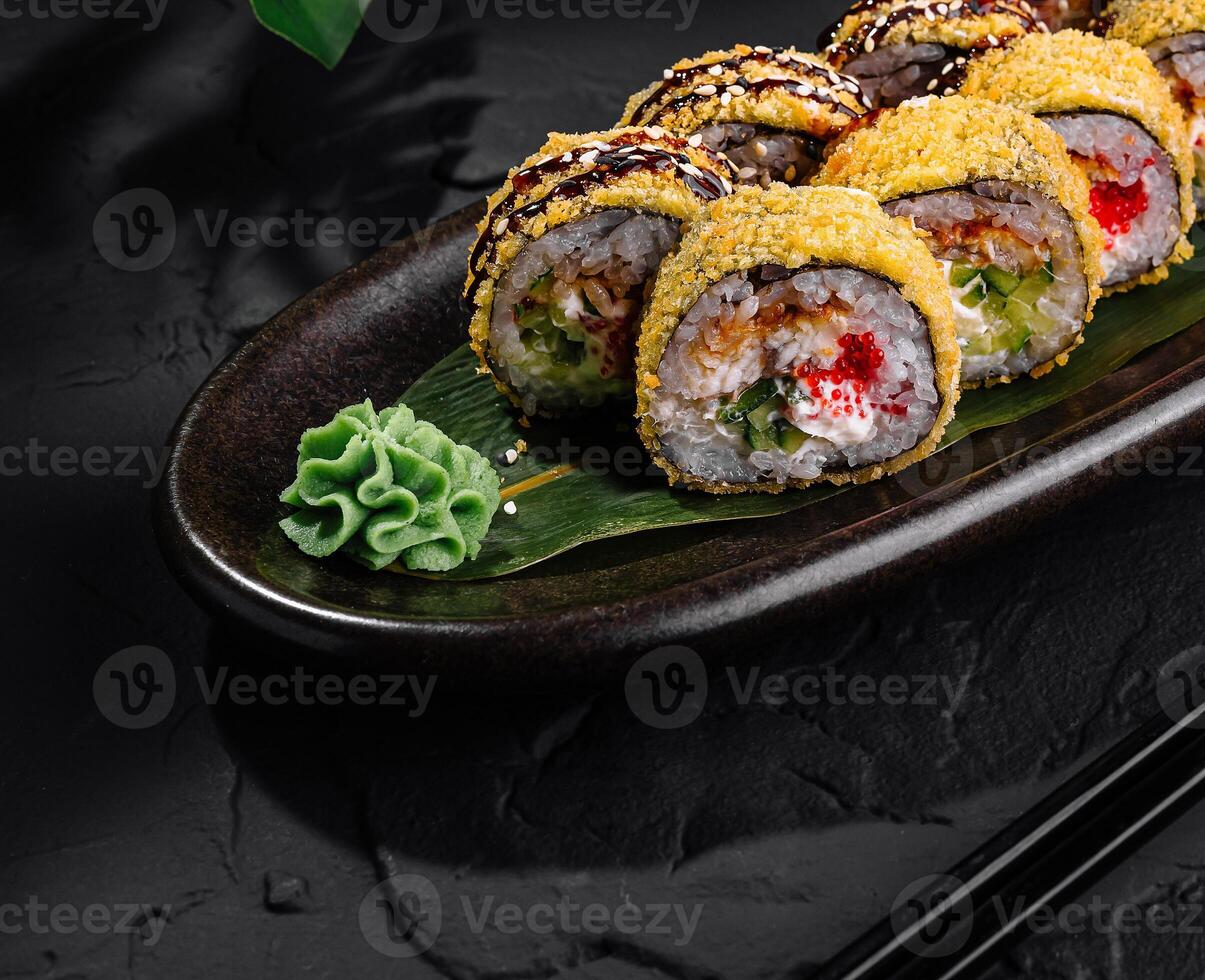 Delectable sushi rolls plated on dark slate background photo