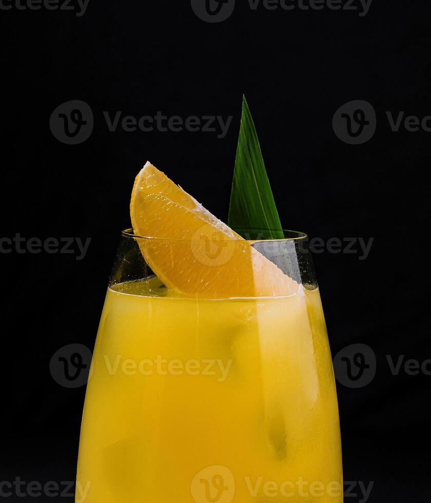 Fresh orange cocktail on dark background photo