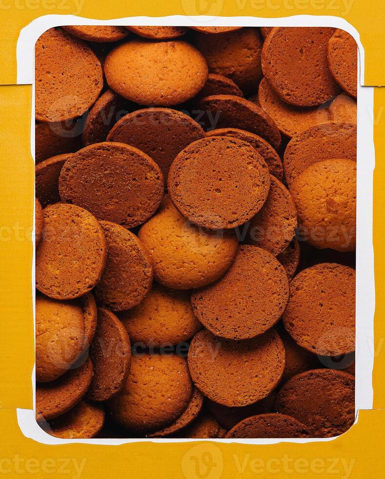 Box of round brown cookies close up photo
