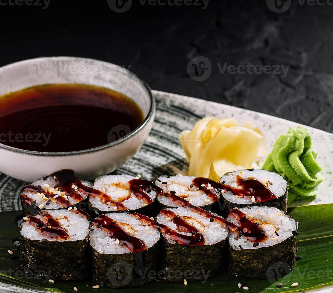 Elegant sushi rolls on slate background photo