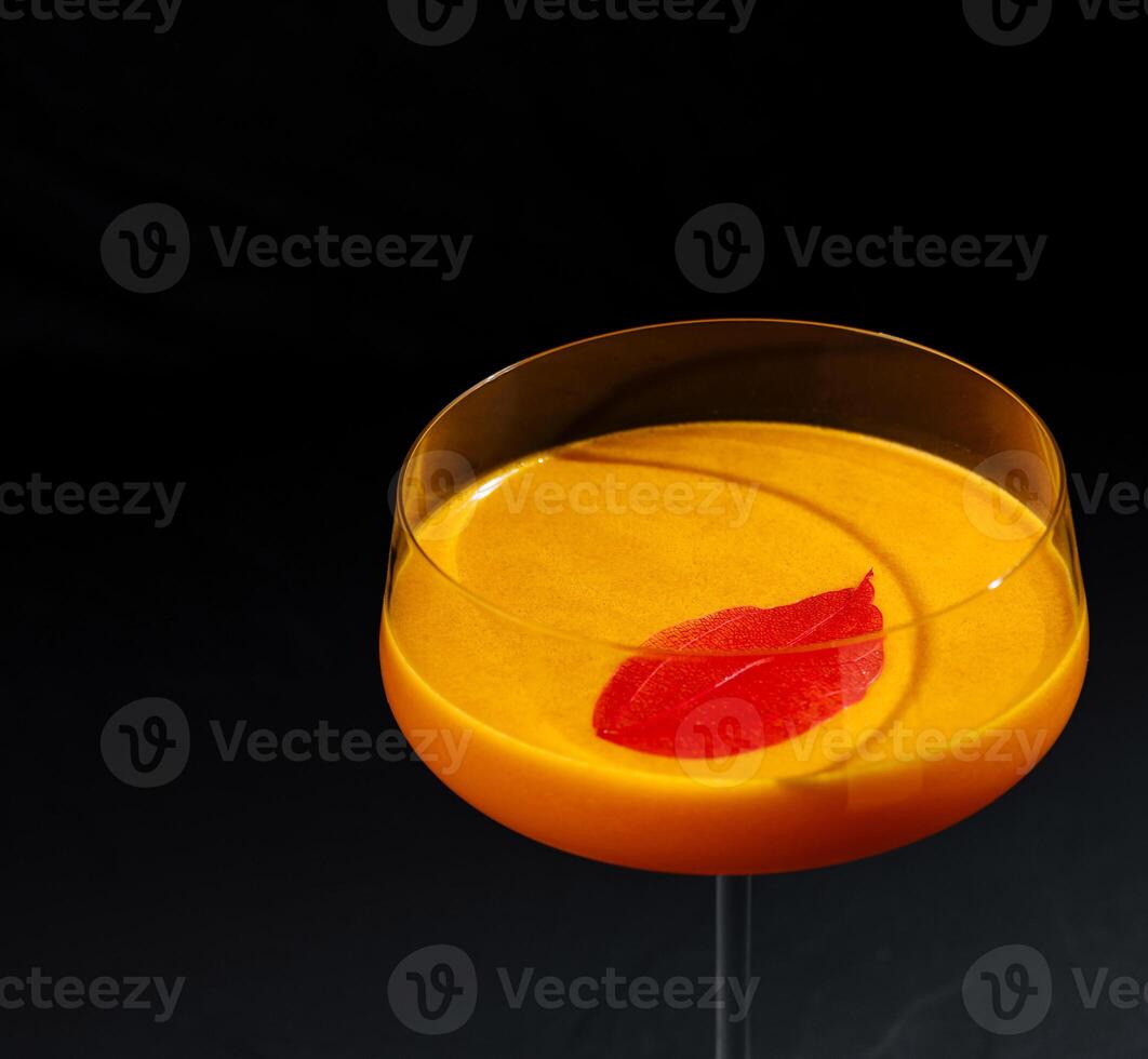 Elegant cocktail with citrus garnish on dark backdrop photo