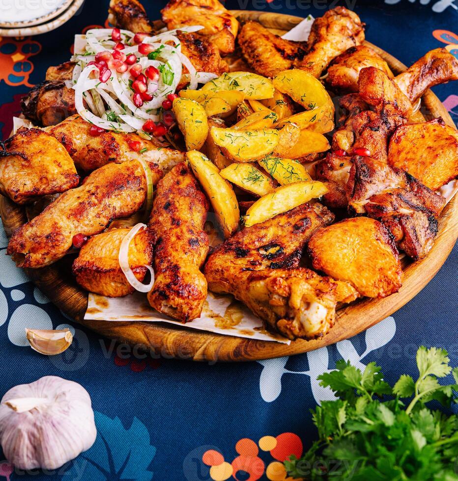 Traditional spicy roasted chicken and potatoes feast photo