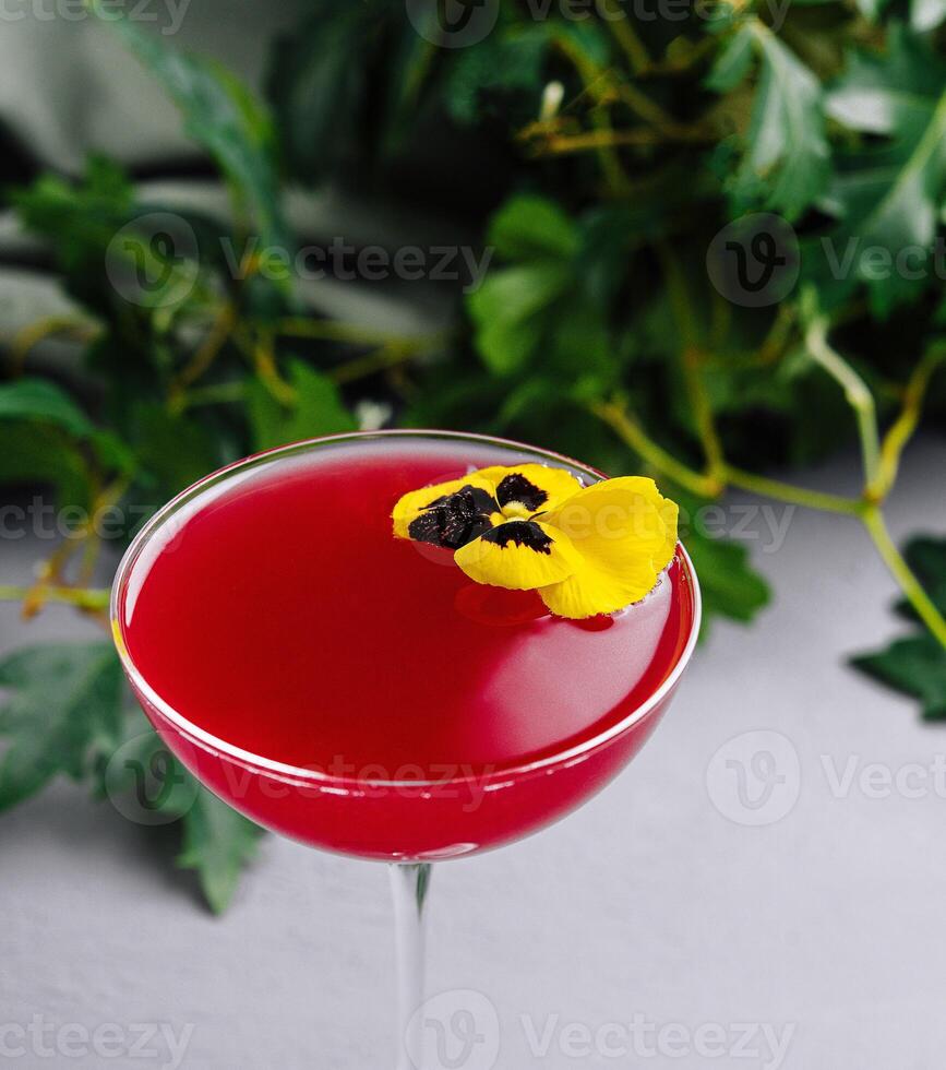 Elegant cocktail with edible flower garnish photo