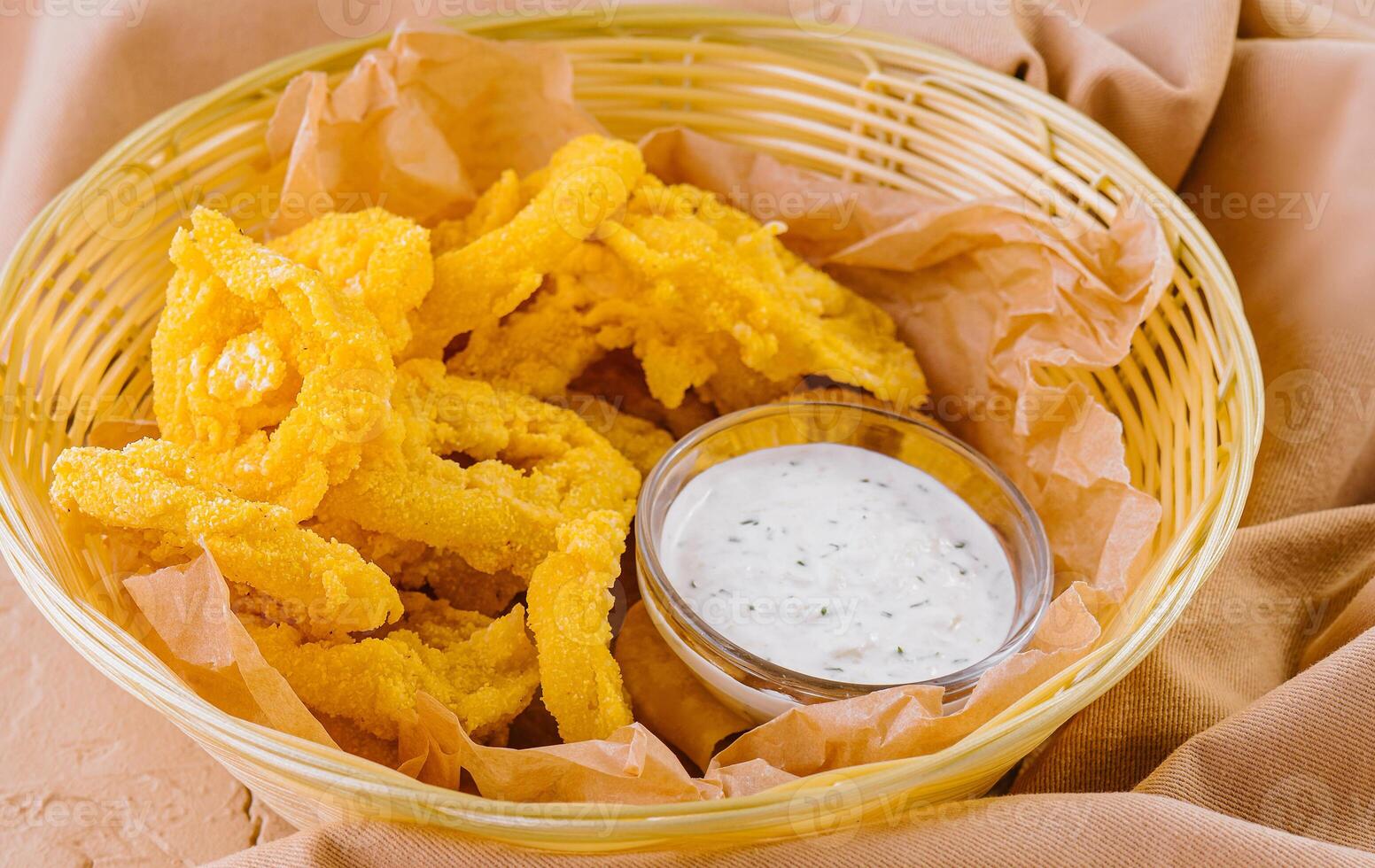 Crunchy breaded shrimp with dipping sauce and chips photo