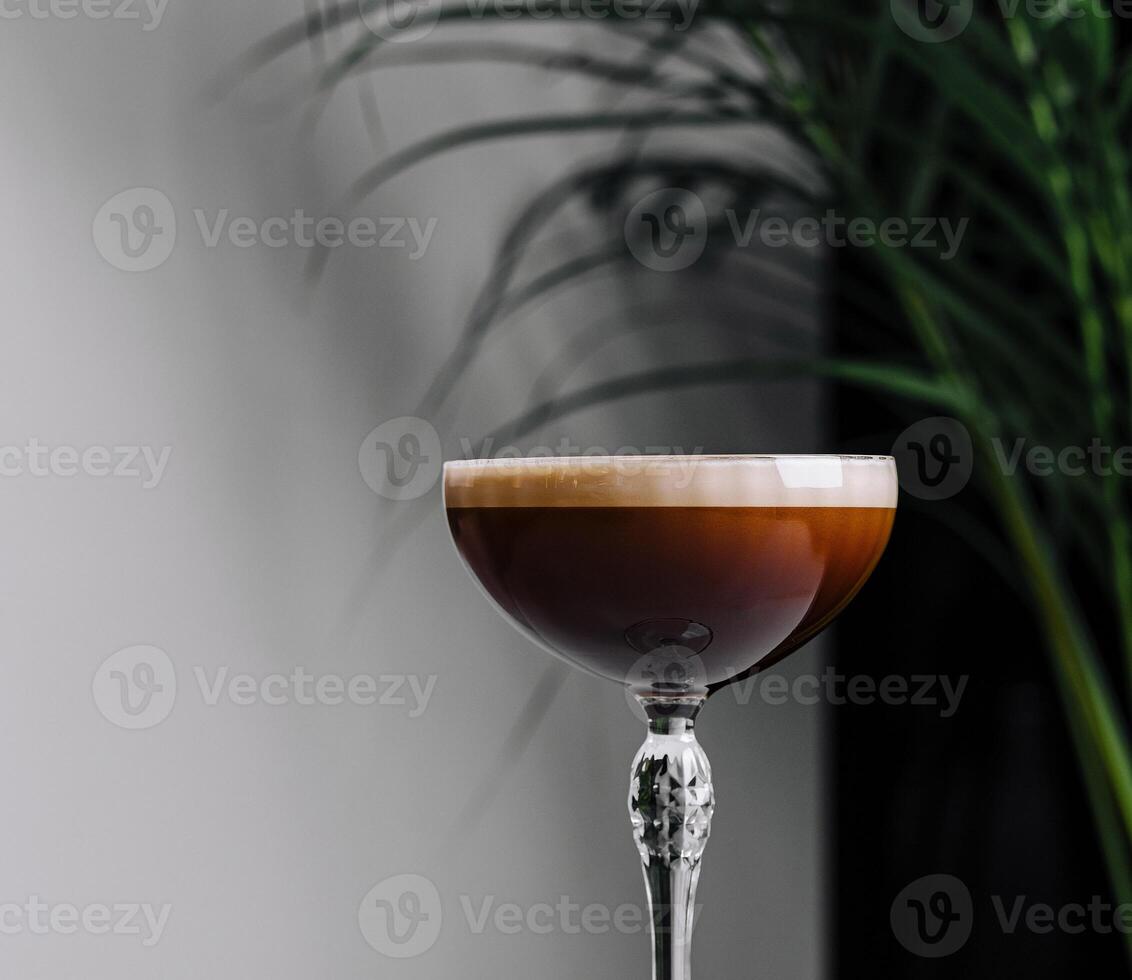 Elegant espresso martini cocktail on white table photo