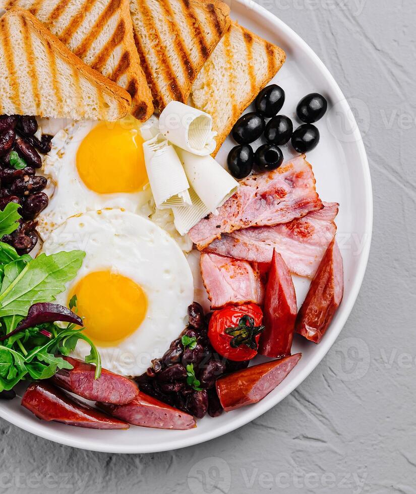 Full breakfast plate with eggs, bacon, and toast photo