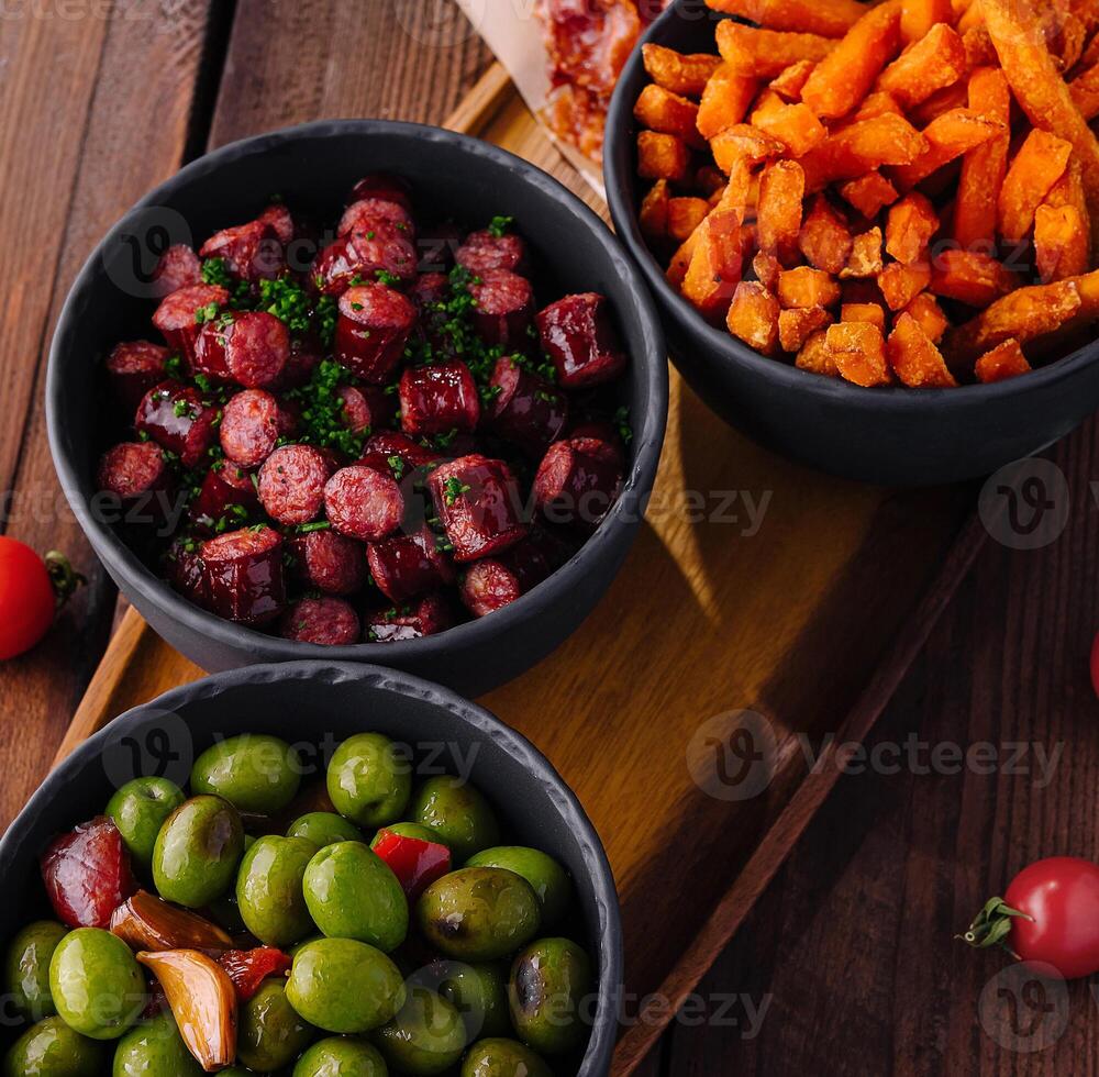 Assorted tapas platter with olives and snacks photo