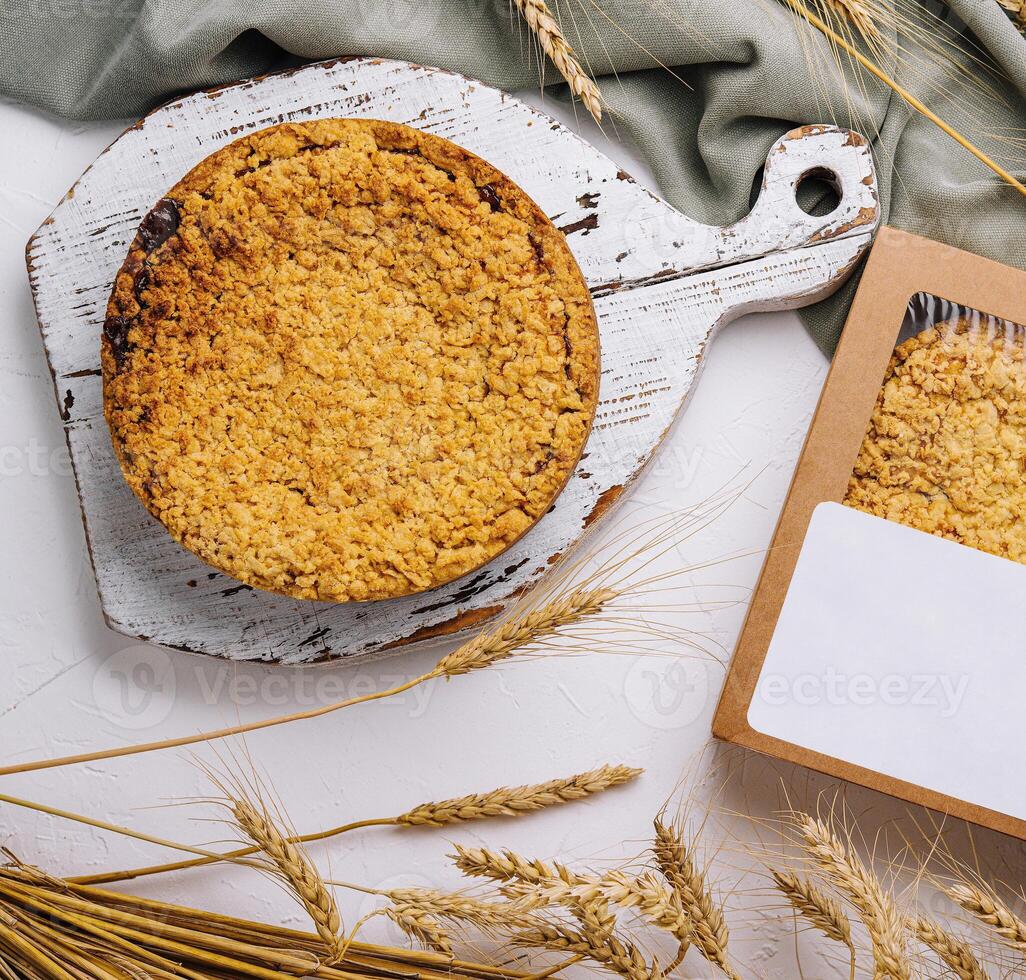 Homemade apple crumble pie with wheat decoration photo