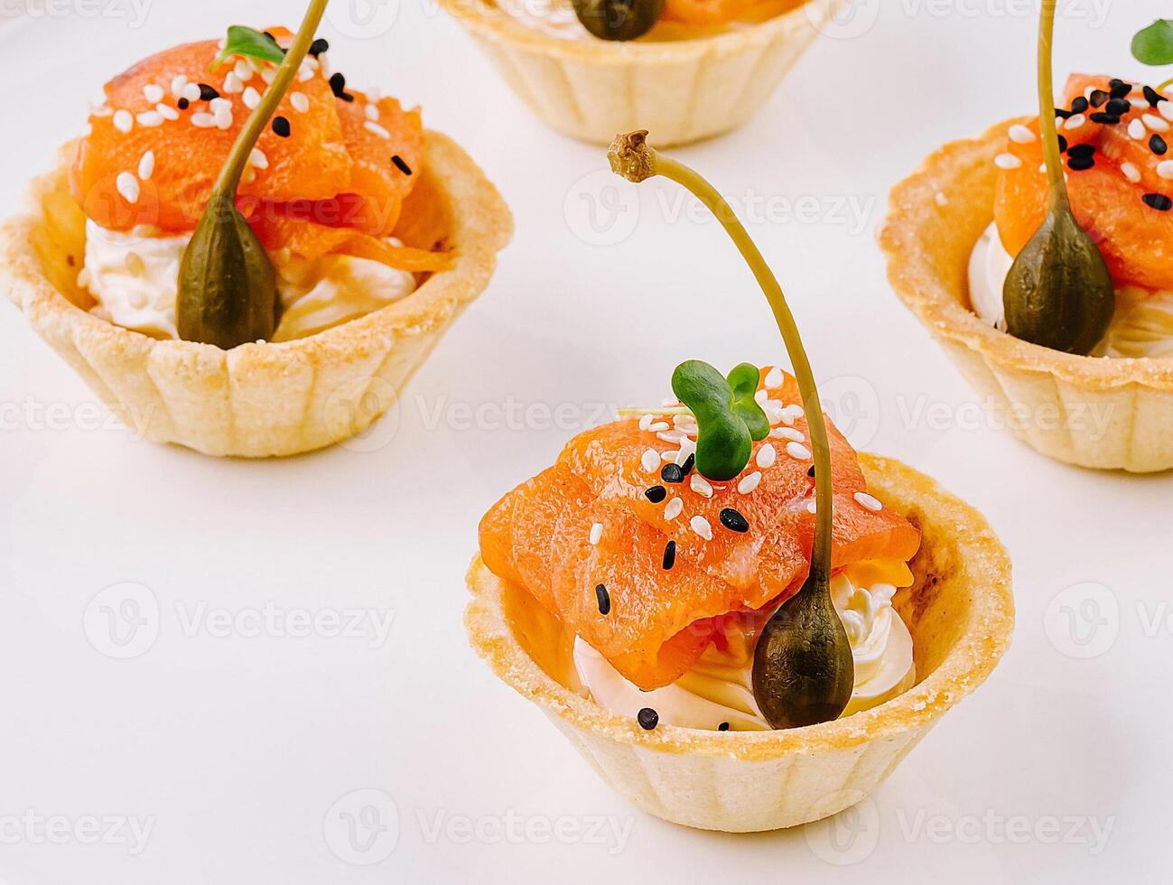 Gourmet smoked salmon tartlets on white plate photo