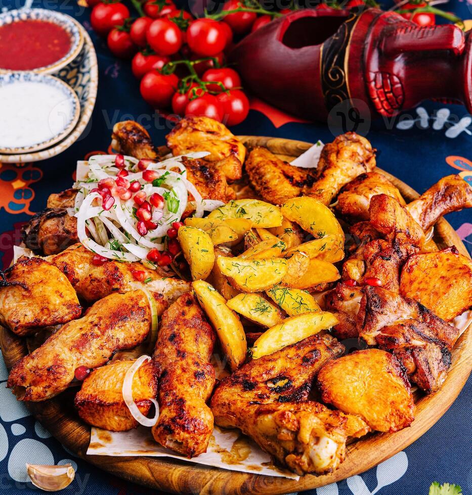 Traditional spicy roasted chicken and potatoes feast photo