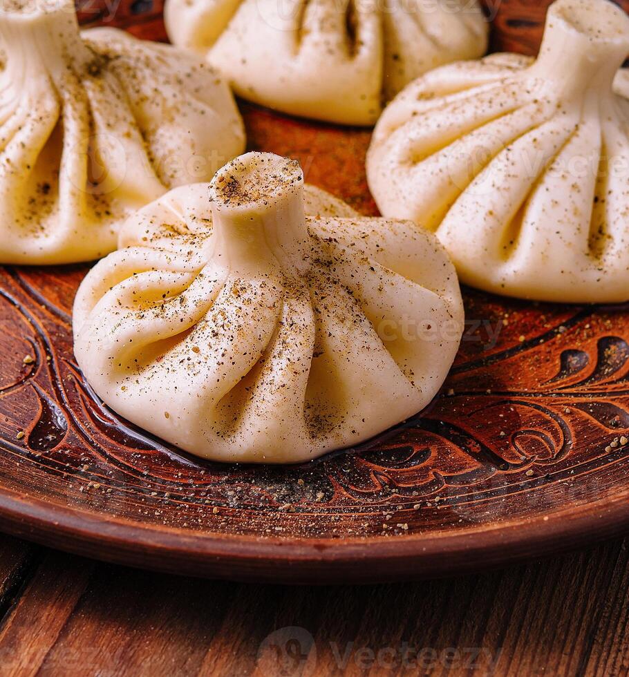Georgian khinkali on traditional plate photo