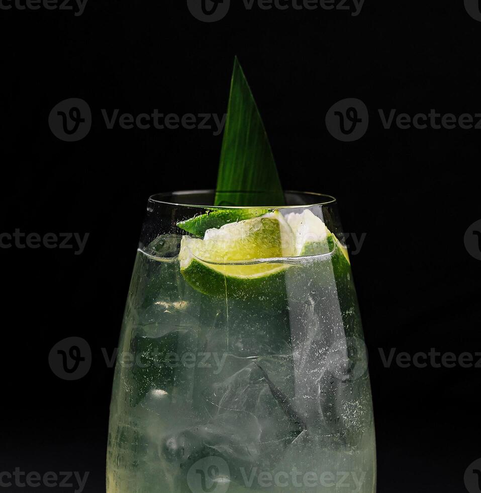 Refreshing lime cocktail on dark background photo
