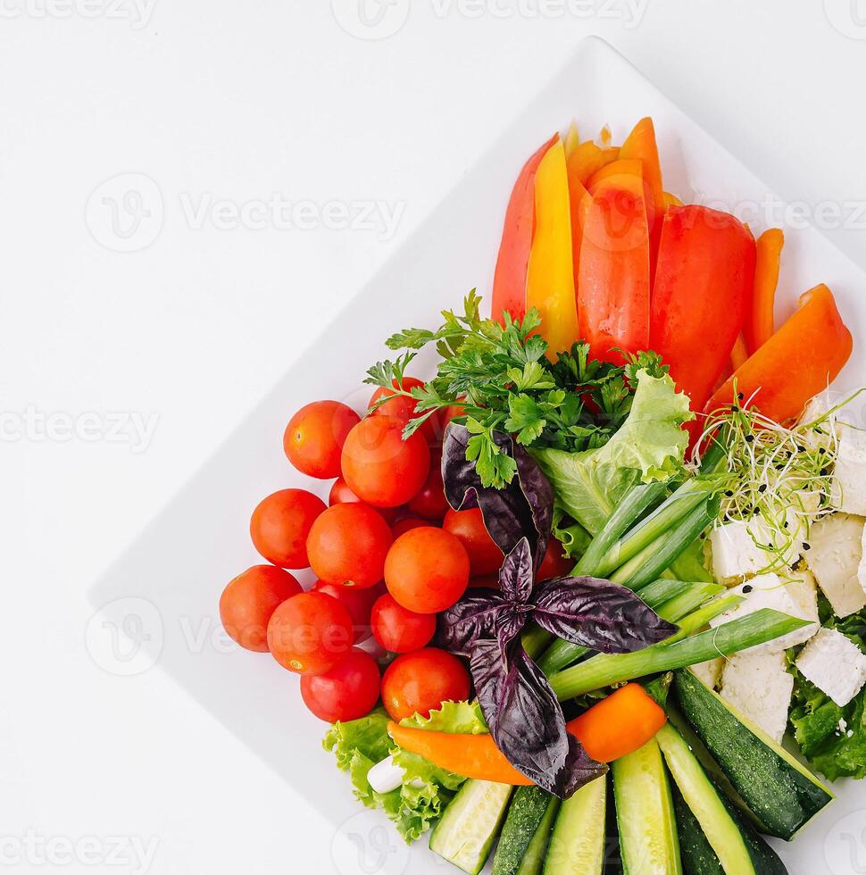 Fresh vegetable platter on white background photo