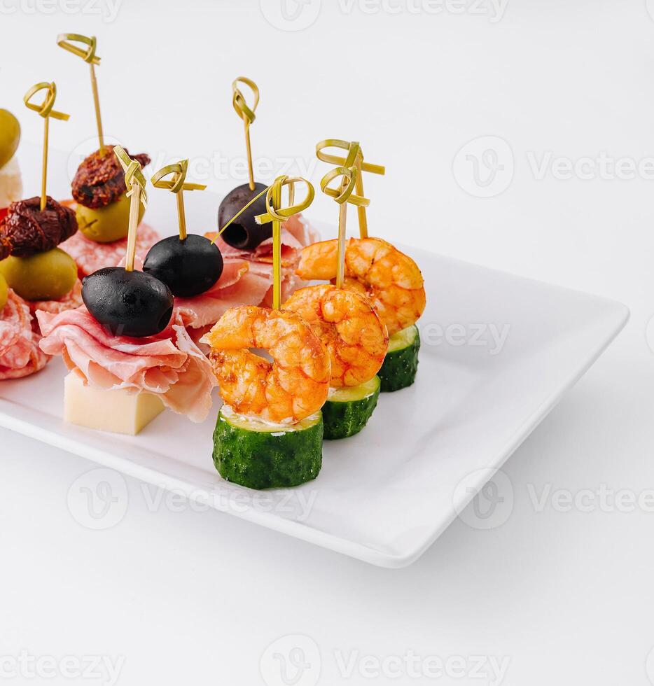 Gourmet appetizer selection on a white platter against a clean backdrop photo
