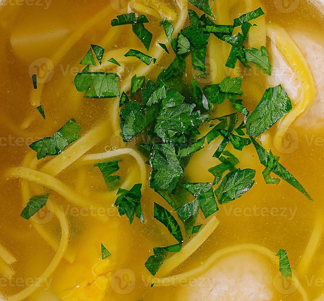 Homemade chicken noodle soup in bowl photo