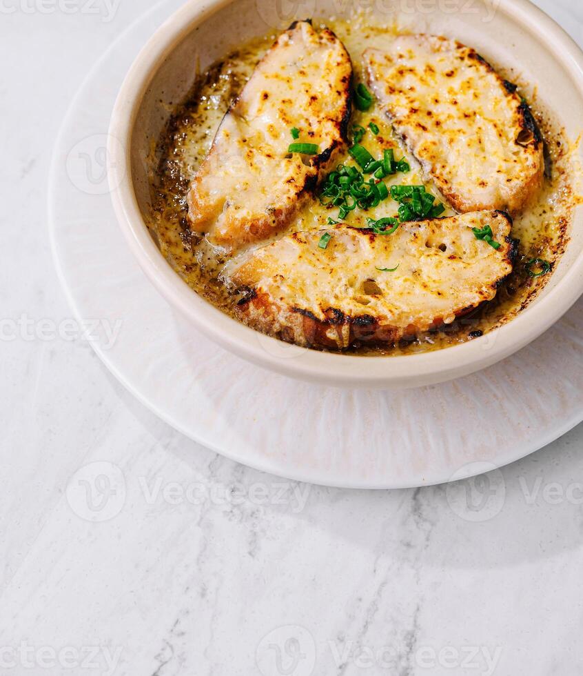Homemade french onion soup with melted cheese photo